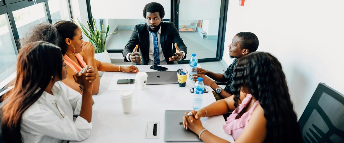 A group of people sitting around a white table